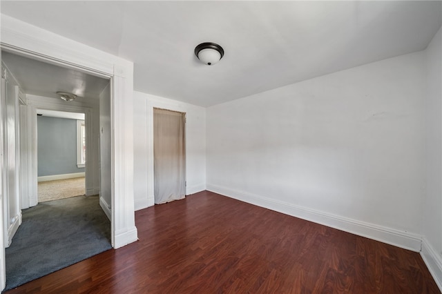 empty room with dark hardwood / wood-style floors