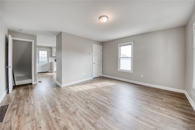 empty room with light hardwood / wood-style flooring