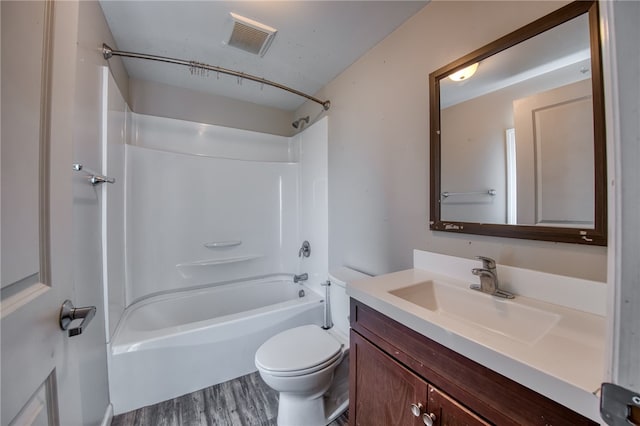 full bathroom featuring vanity, shower / washtub combination, wood-type flooring, and toilet