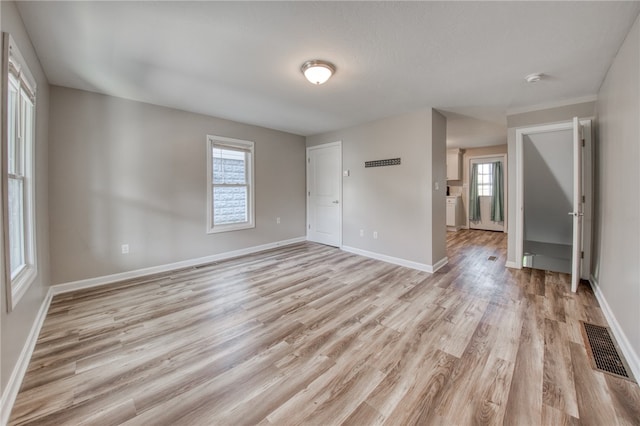 empty room with light hardwood / wood-style flooring