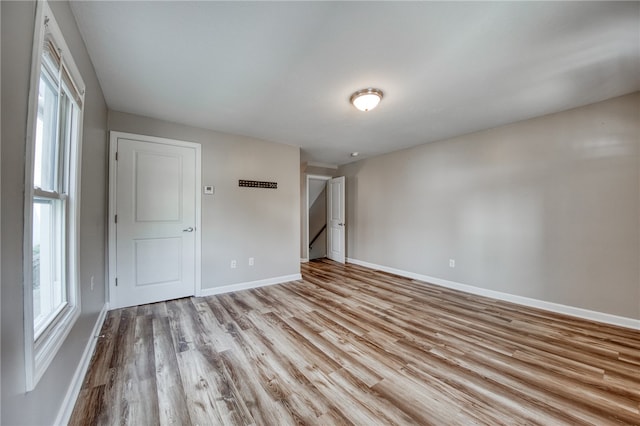 spare room with light hardwood / wood-style flooring