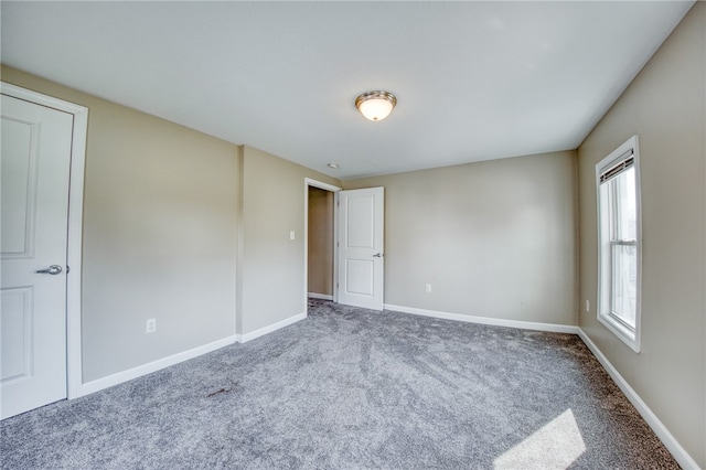 carpeted spare room with a healthy amount of sunlight