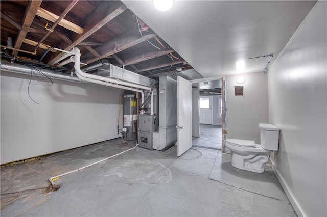 basement featuring gas water heater and heating unit