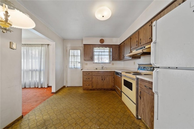 26 Petrak St, Fallowfield, PA 15022 - kitchen with white appliances, under cabinet range hood, dark floors, light countertops, and brown cabinetry