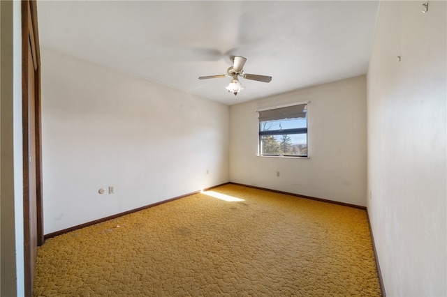 spare room featuring carpet and ceiling fan