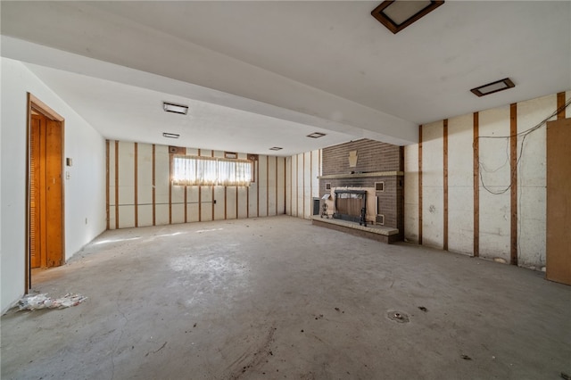 unfurnished living room featuring a brick fireplace