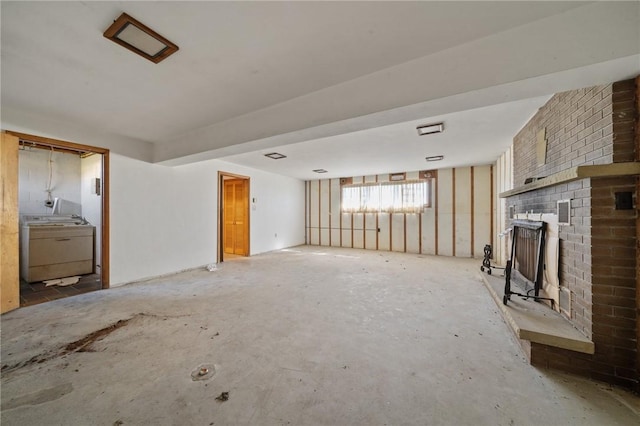 26 Petrak St, Fallowfield, PA 15022 - unfurnished living room with washer / dryer and a brick fireplace