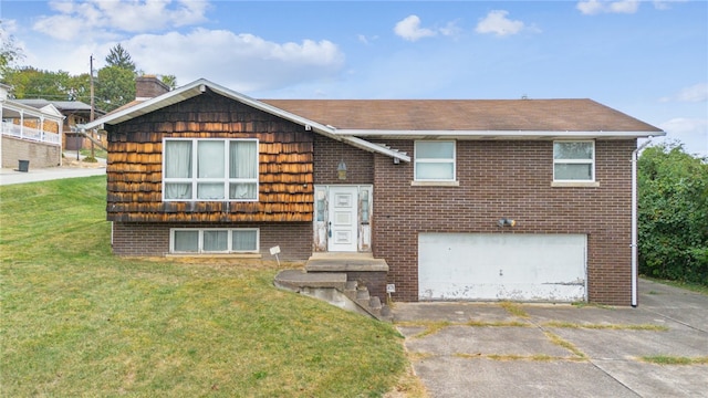 raised ranch featuring a front yard and a garage