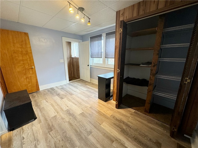 interior space featuring light hardwood / wood-style flooring and rail lighting