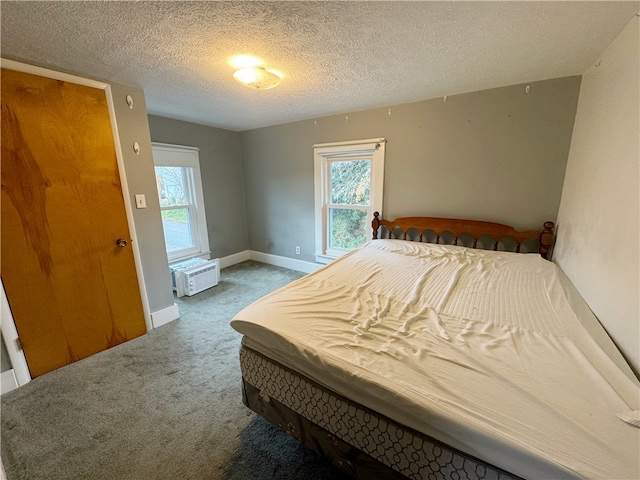 carpeted bedroom with a textured ceiling