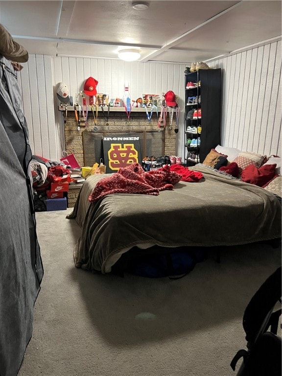 carpeted bedroom with wood walls