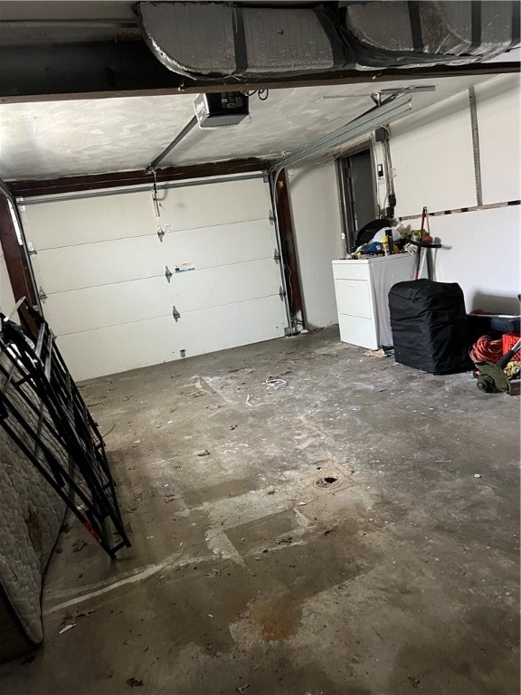 garage featuring washer / dryer and a garage door opener