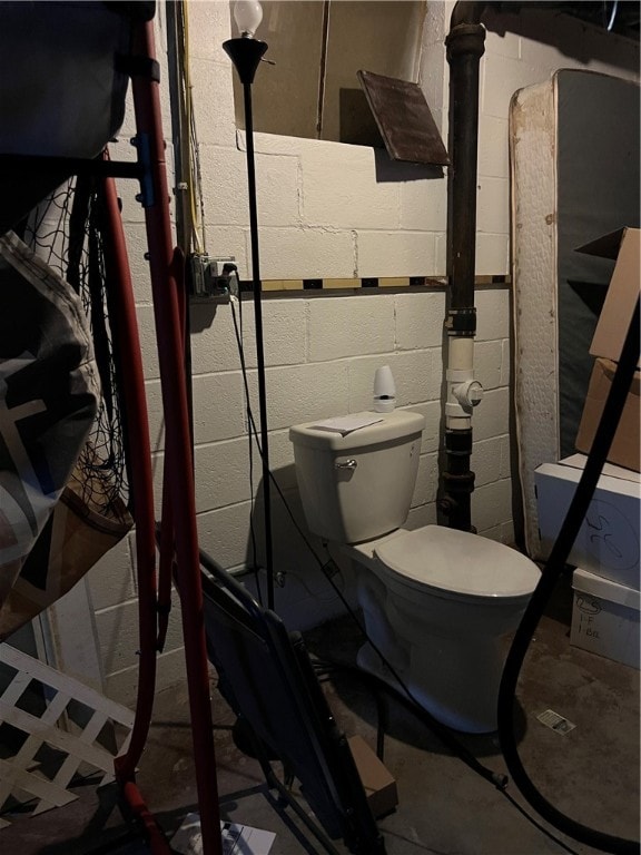 bathroom featuring concrete floors and toilet