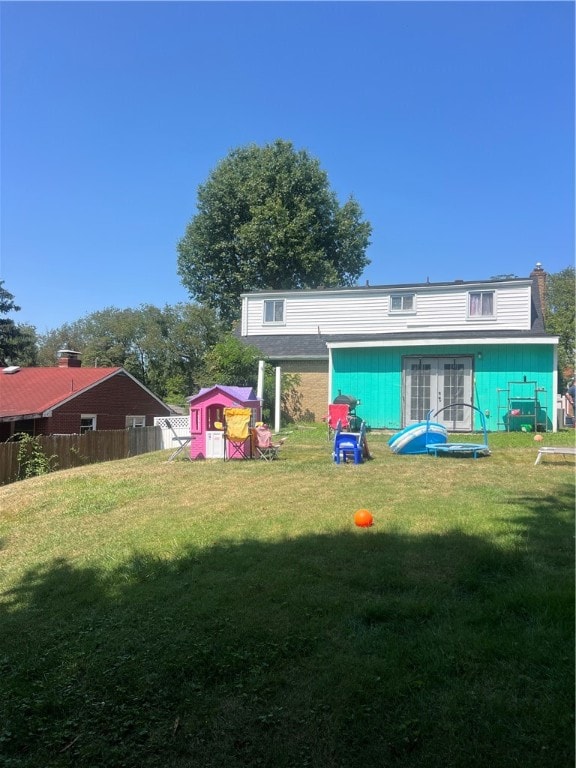 rear view of property with a lawn