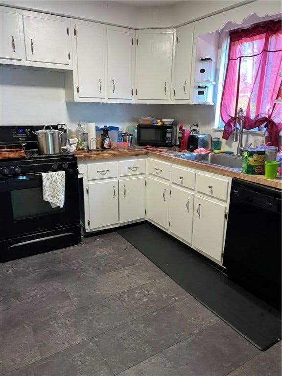 kitchen with white cabinetry and black appliances