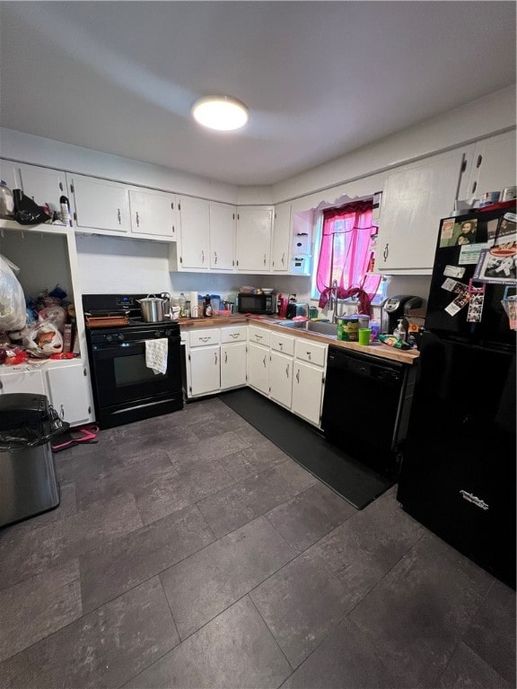 kitchen with sink, black appliances, and white cabinetry