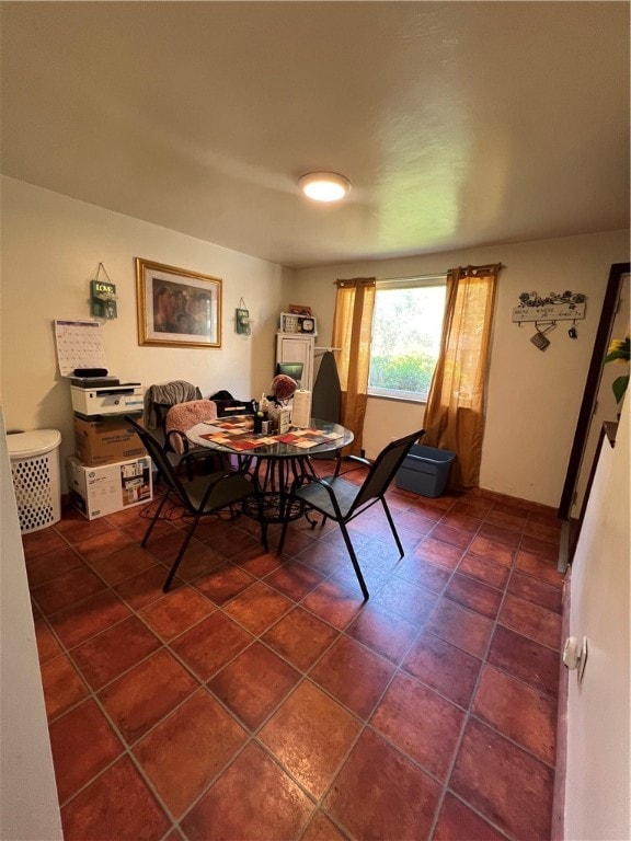 dining area with dark tile patterned floors