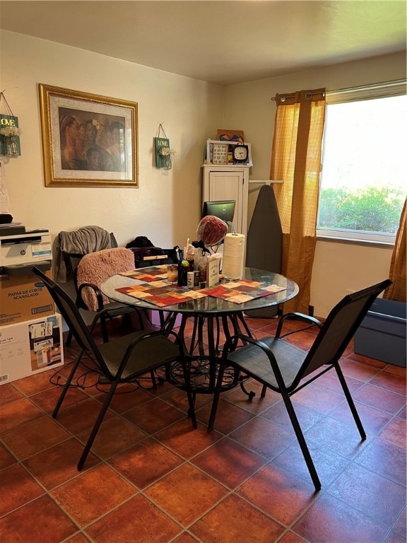 dining area featuring dark tile patterned floors