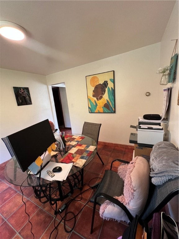 dining space featuring dark tile patterned flooring