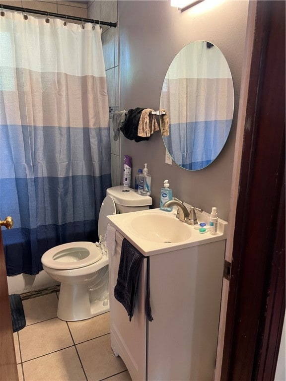 bathroom with vanity, toilet, and tile patterned floors