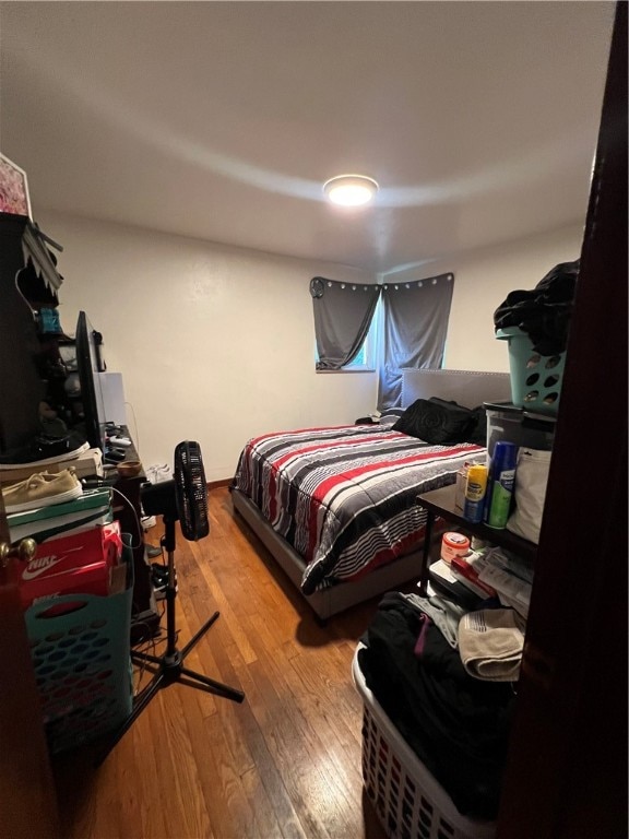 bedroom with wood-type flooring