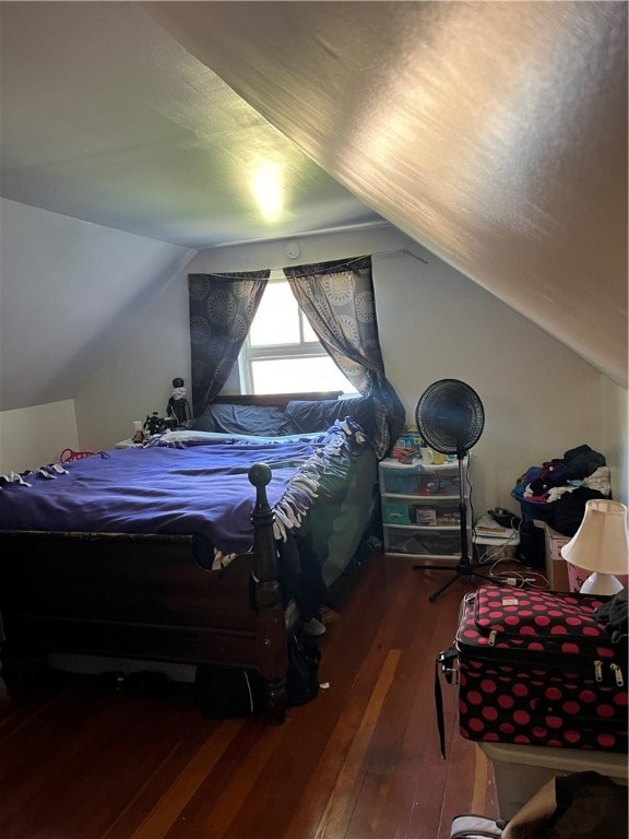 bedroom with lofted ceiling and hardwood / wood-style flooring