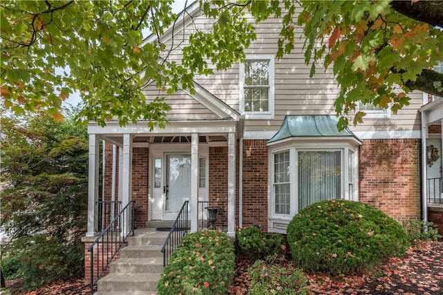 view of exterior entry with covered porch