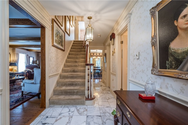 interior space with ornamental molding, beamed ceiling, and hardwood / wood-style floors