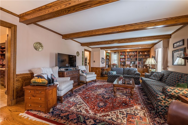 living room featuring beamed ceiling, wood-type flooring, and wood walls