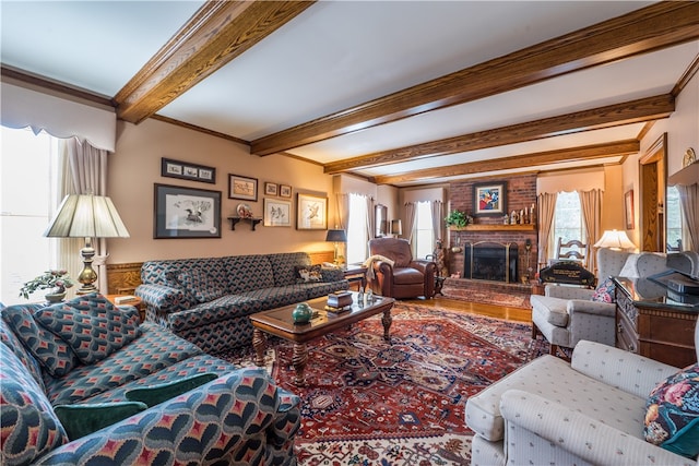 living room with beamed ceiling, a fireplace, and a wealth of natural light