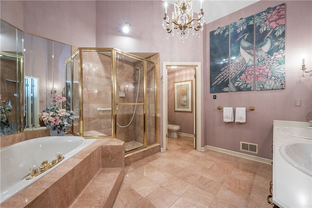 full bathroom featuring an inviting chandelier, vanity, plus walk in shower, and toilet