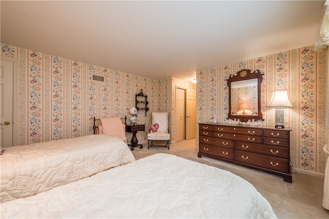 bedroom featuring light carpet and a closet