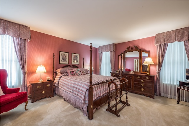 carpeted bedroom featuring multiple windows