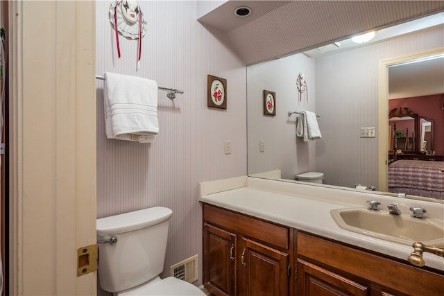 bathroom with toilet and vanity