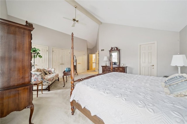 bedroom featuring two closets, light colored carpet, ceiling fan, high vaulted ceiling, and beamed ceiling