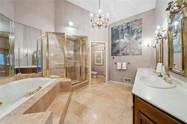 bathroom featuring toilet, a sink, visible vents, double vanity, and a stall shower