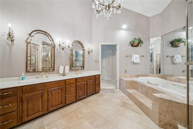 full bath with a high ceiling, a sink, a bath, and double vanity