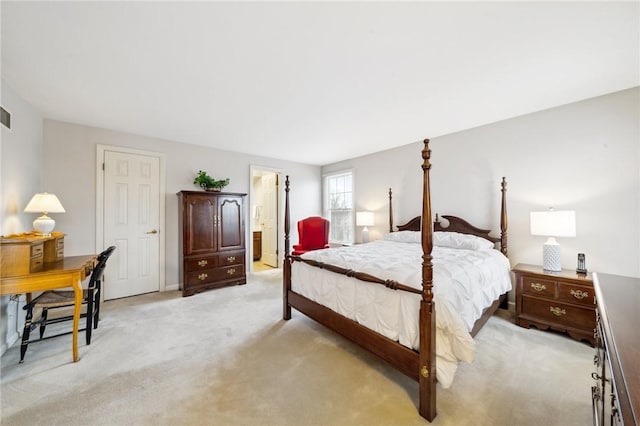 bedroom with light colored carpet, visible vents, and ensuite bath