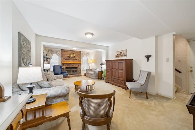 carpeted living room featuring a brick fireplace and baseboards