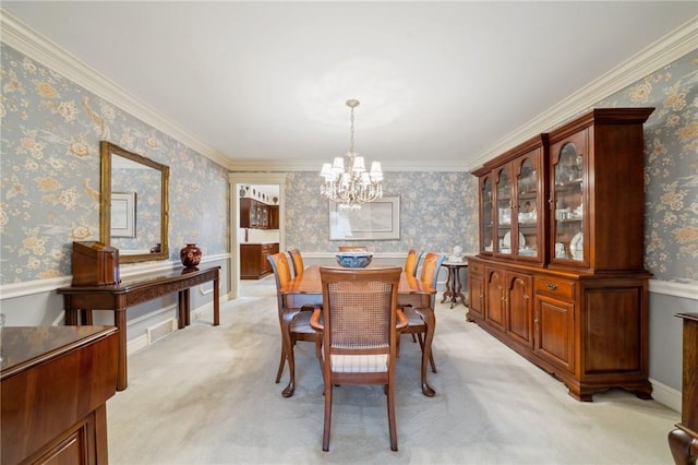 dining area featuring a chandelier, light carpet, ornamental molding, and wallpapered walls