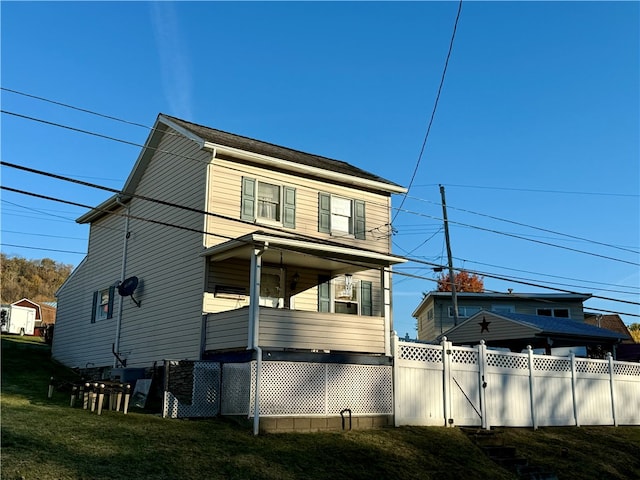 rear view of house featuring a yard