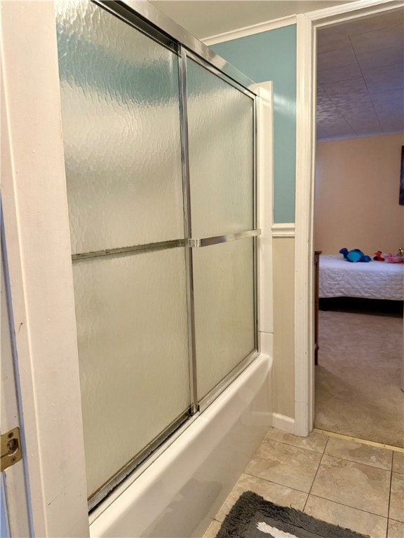 bathroom featuring tile patterned floors and bath / shower combo with glass door