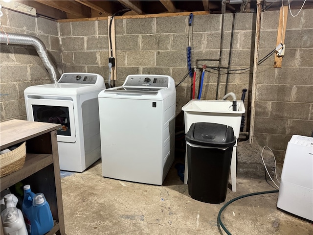 clothes washing area featuring washer and dryer and sink