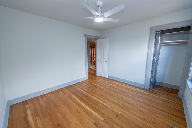 unfurnished bedroom with light hardwood / wood-style floors, a closet, and ceiling fan