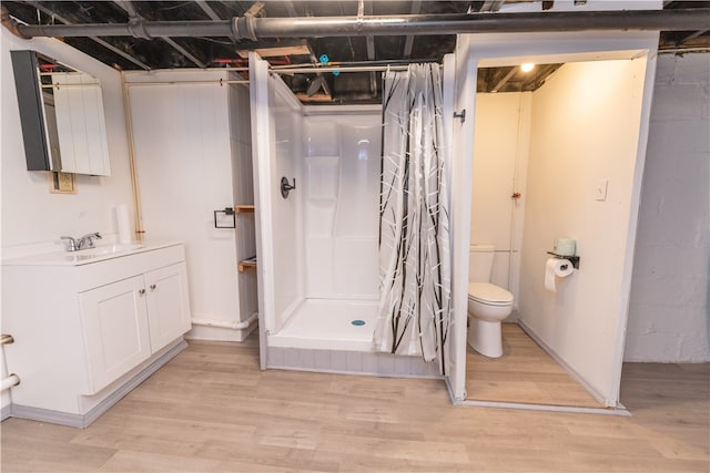 bathroom featuring vanity, a shower with curtain, toilet, and hardwood / wood-style flooring