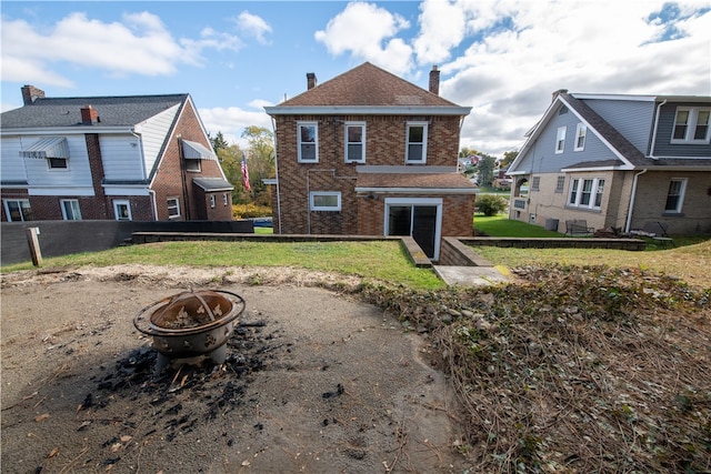 back of property featuring an outdoor fire pit