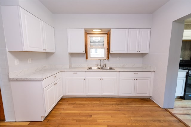 kitchen featuring light hardwood / wood-style flooring, white cabinetry, and white range oven