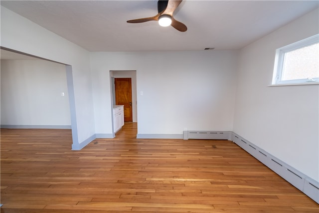 spare room with light hardwood / wood-style floors and ceiling fan