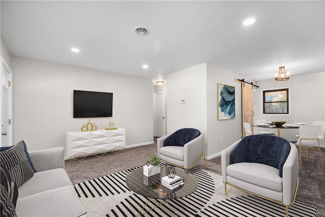 living room featuring a barn door and carpet floors