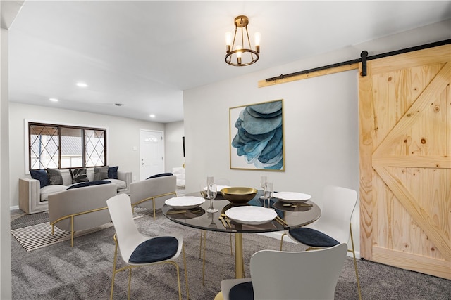 carpeted dining space with an inviting chandelier and a barn door